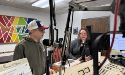 Johnny Wadzkinski and Lacey Hein in the studio talking on microphones